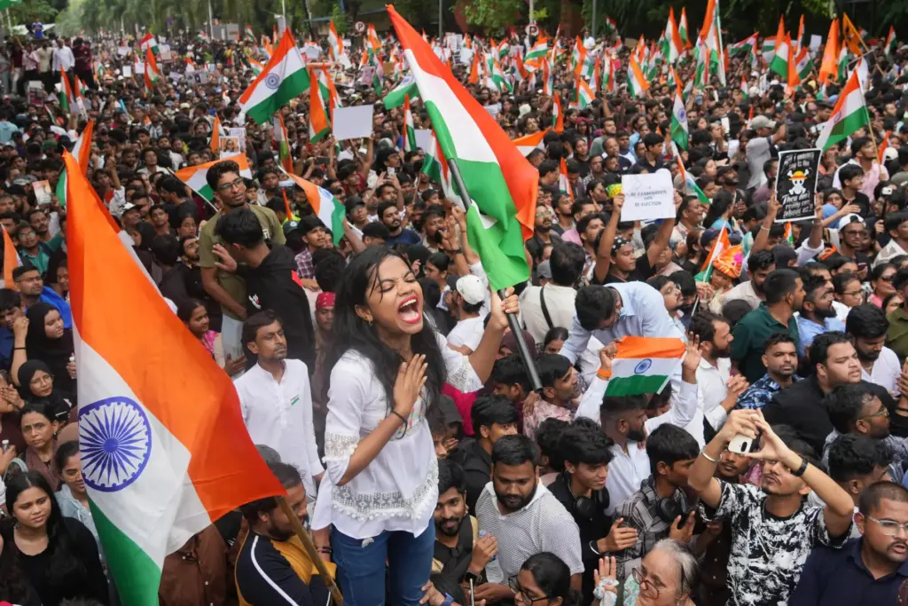 Protesters celebrate after Education Minister Dharmendra Pradhan resigned.