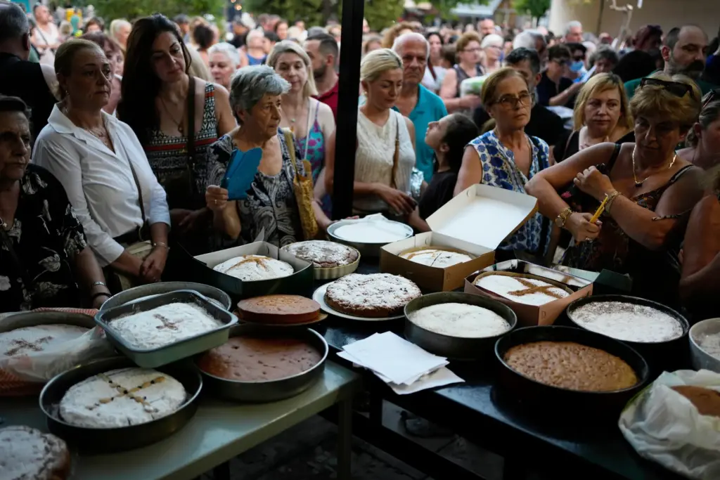 Pilgrims wait to have their Fanouropites, orange-flavored cakes, blessed.