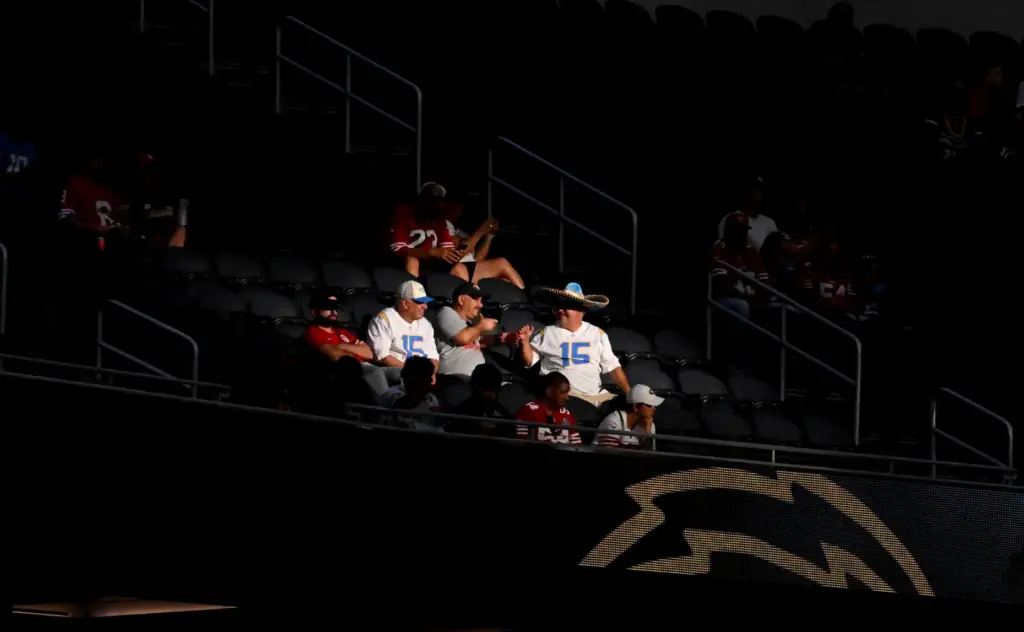 Football fans look on from the stands during the first...