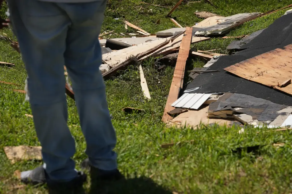 Wreckage from a tornado lies on the ground Friday, Aug....