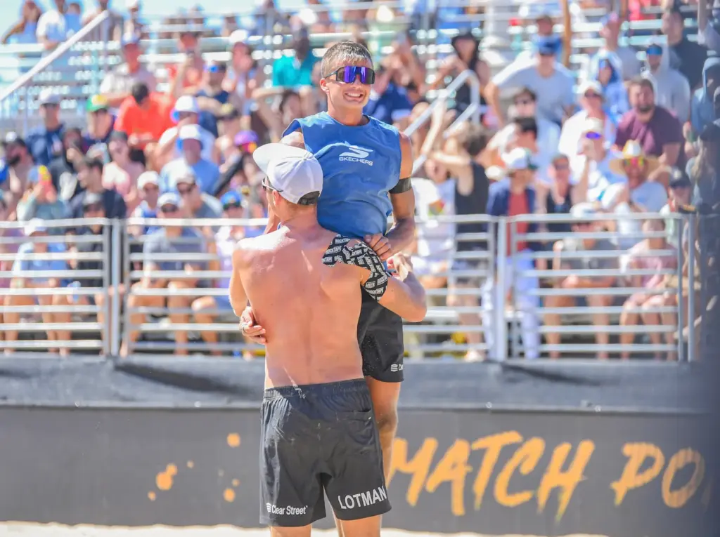 Miles Partain jumps into Paul Lotman’s arms after the sixth-seeded...