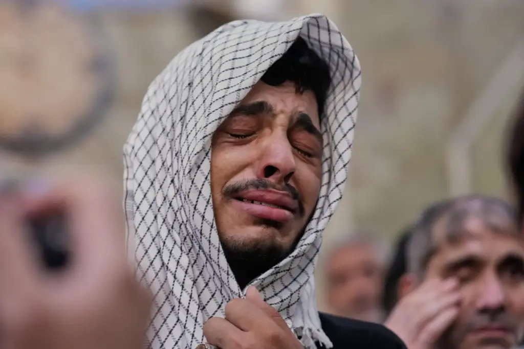 An Irani Shiite Muslim weeps as he prays inside the holy shrine of Imam Abbas.