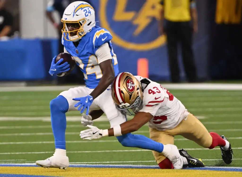 Chargers wide receiver Devonte Ross, left, runs with the ball...