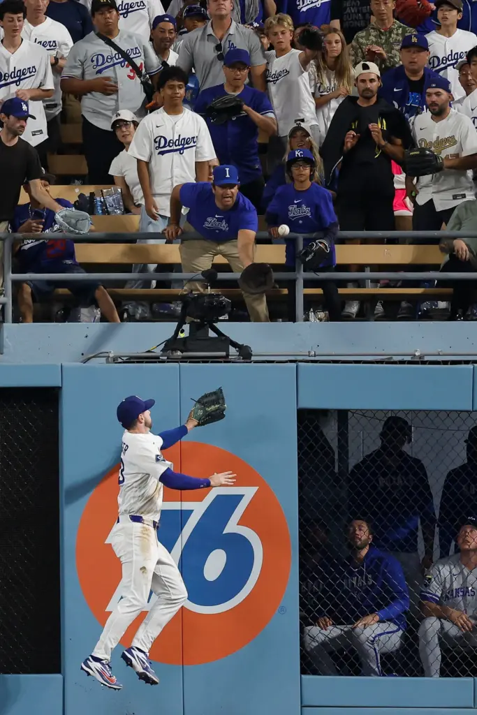 Dodgers right fielder Kyle Tucker (23) leaps to no avail...