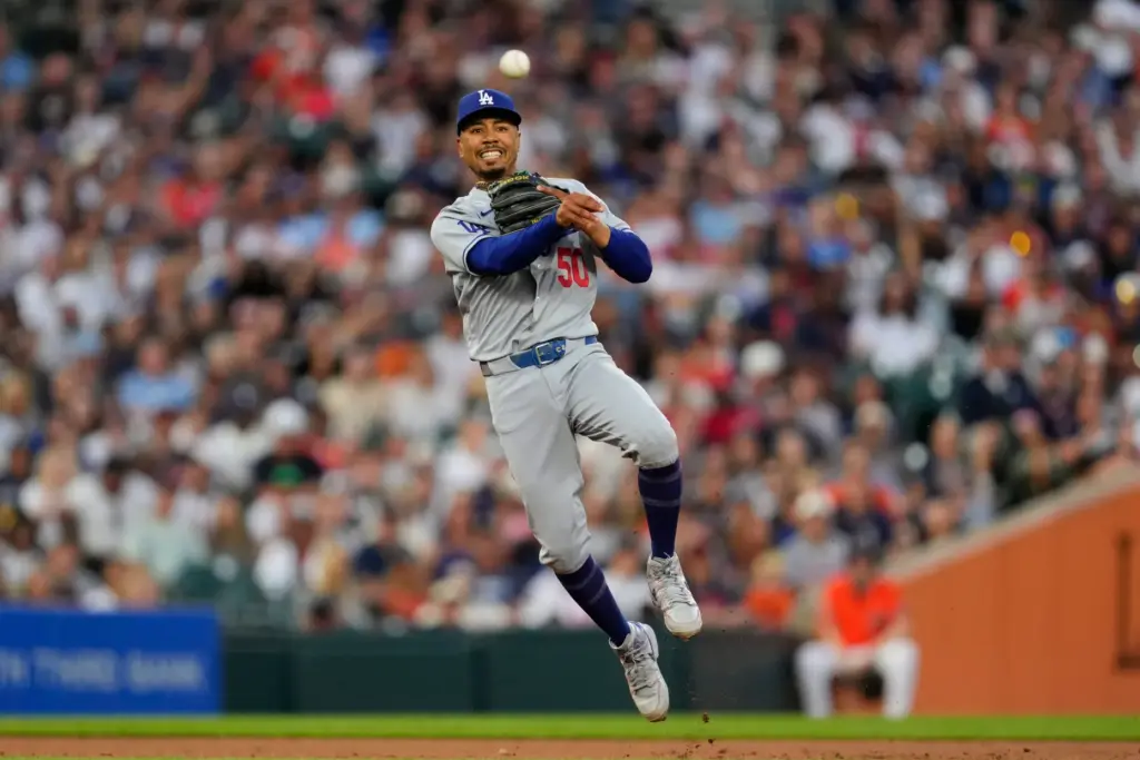 Dodgers shortstop Mookie Betts throws to first base for an...
