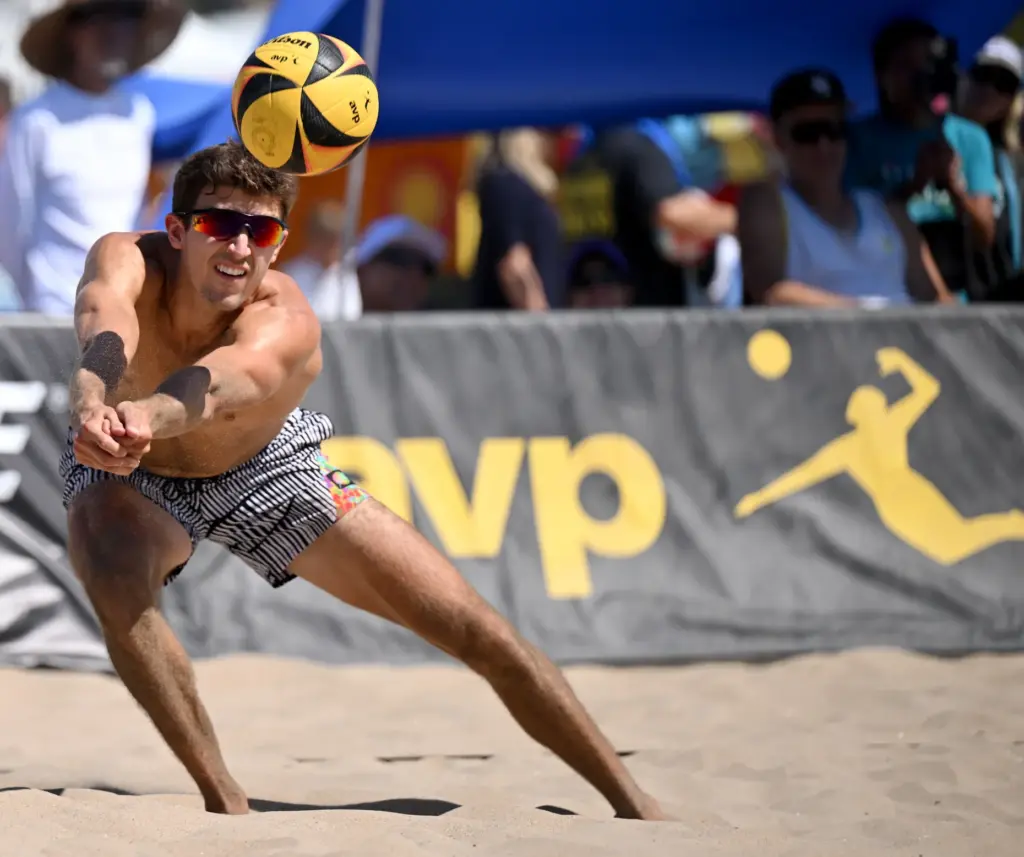 Timothy Brewster digs for the ball as he and Ryan...