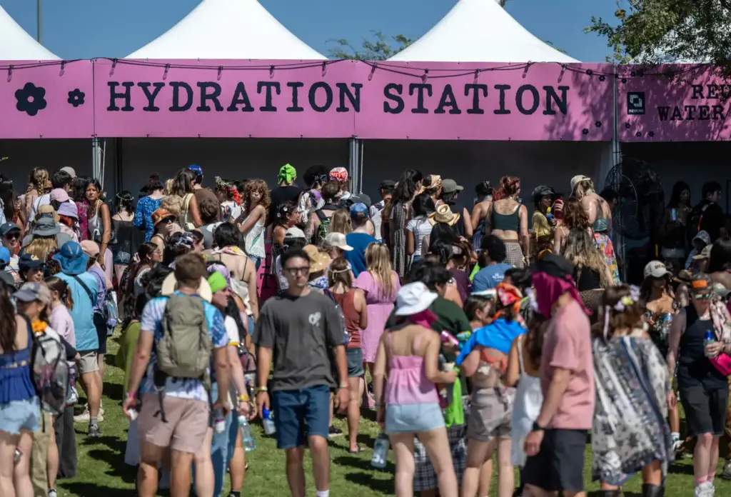 Festivalgoers wait in lines for one of the hydration stations...