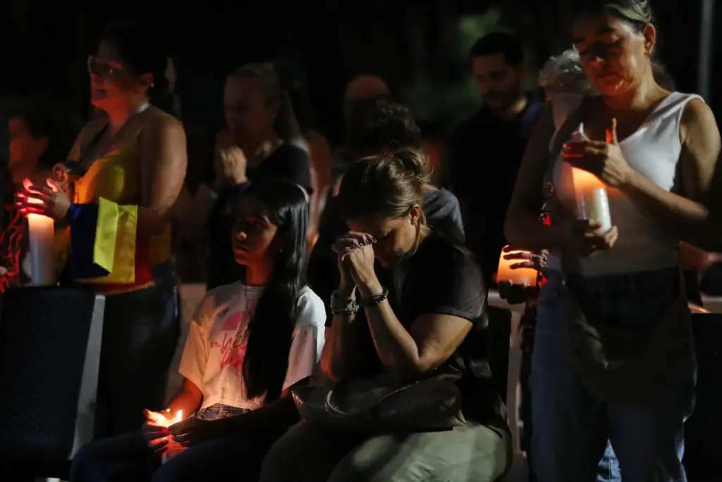 People gather at a vigil for earthquake victims in Cali,...
