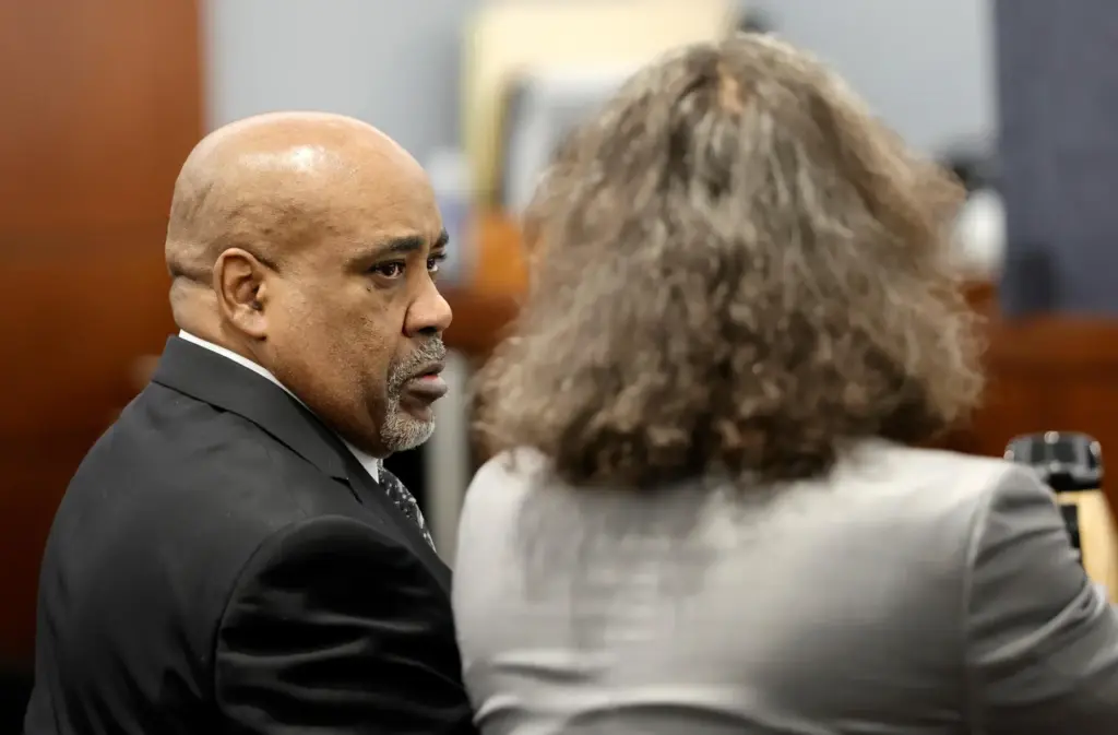 Duane Davis, left, listens to his attorney Michael Sanft during...