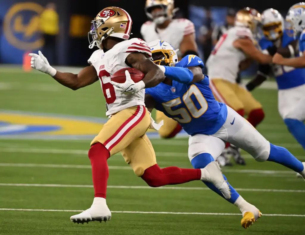 San Francisco 49ers safety Malik Mustapha, left, evades Chargers linebacker...
