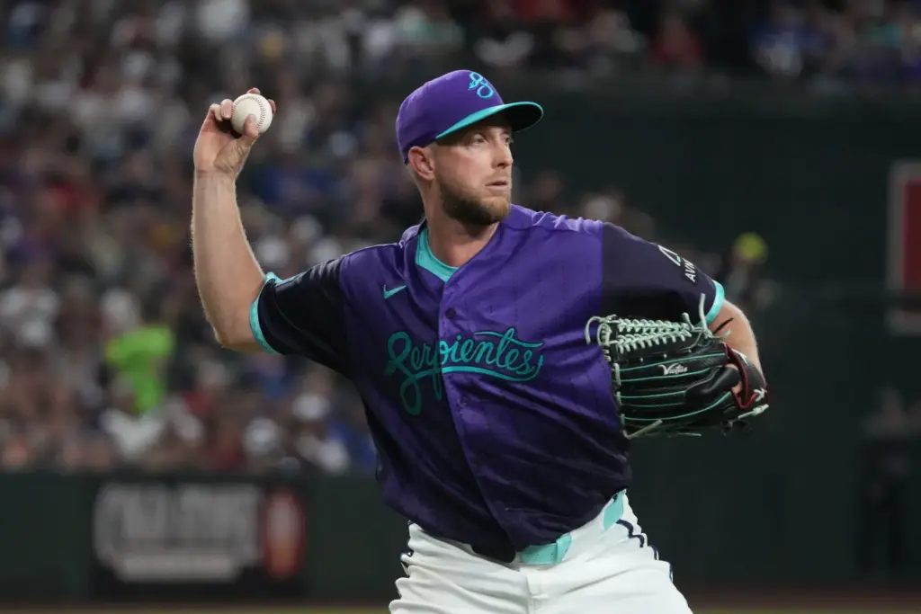 Arizona Diamondbacks starting pitcher Merrill Kelly throws to first base...