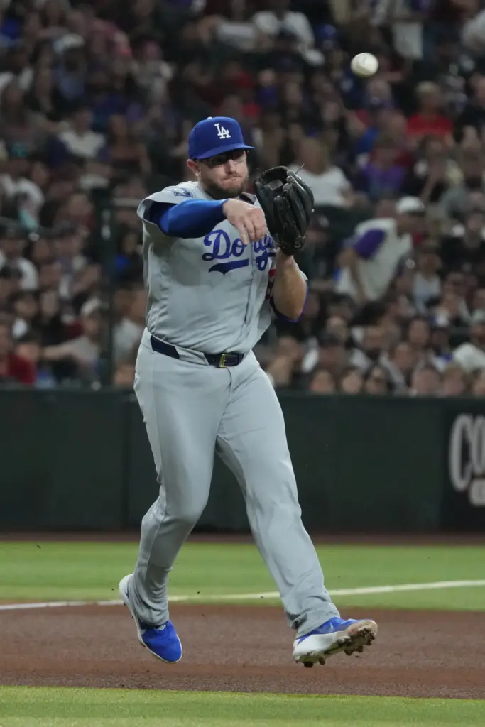 Dodgers third baseman Max Muncy throws to first base during...