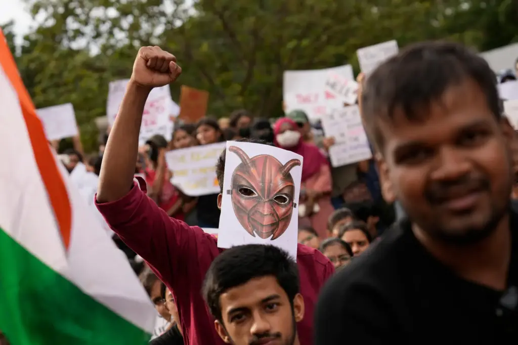 A participant wearing a cockroach mask attends a protest.