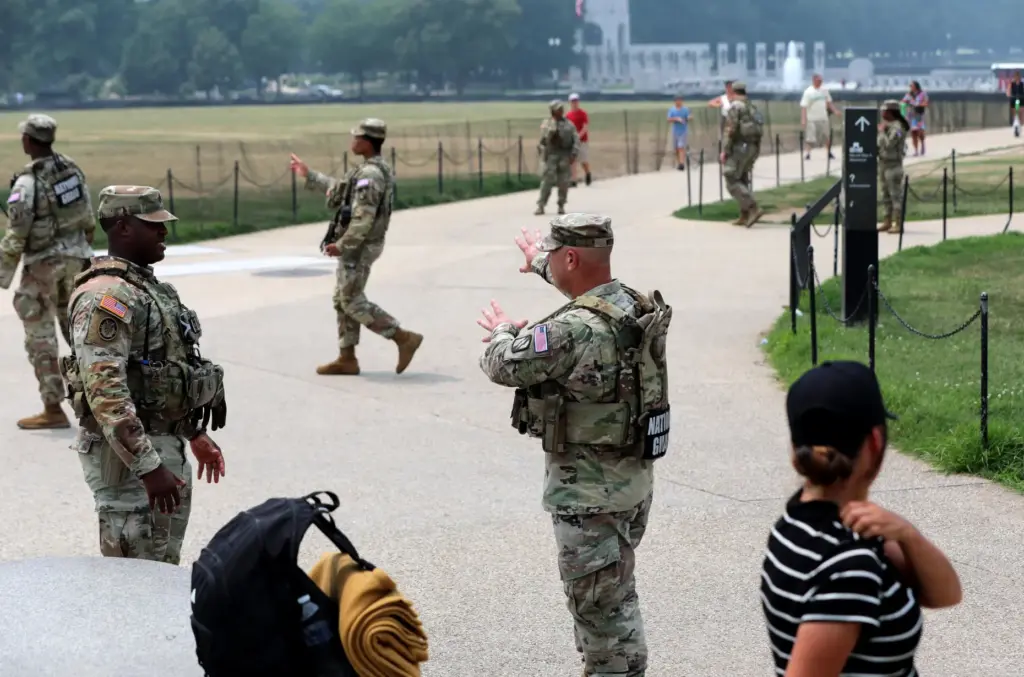 Members of the National Guard patrol around the Washington Monument,...