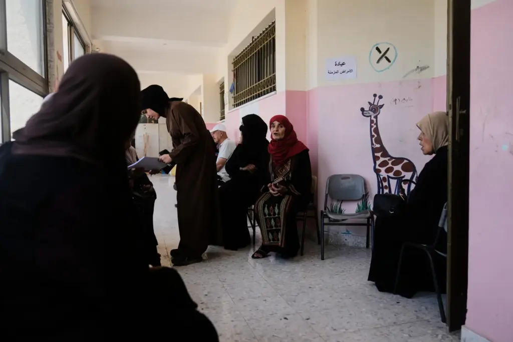 Palestinian patients wait for treatment at a mobile clinic.