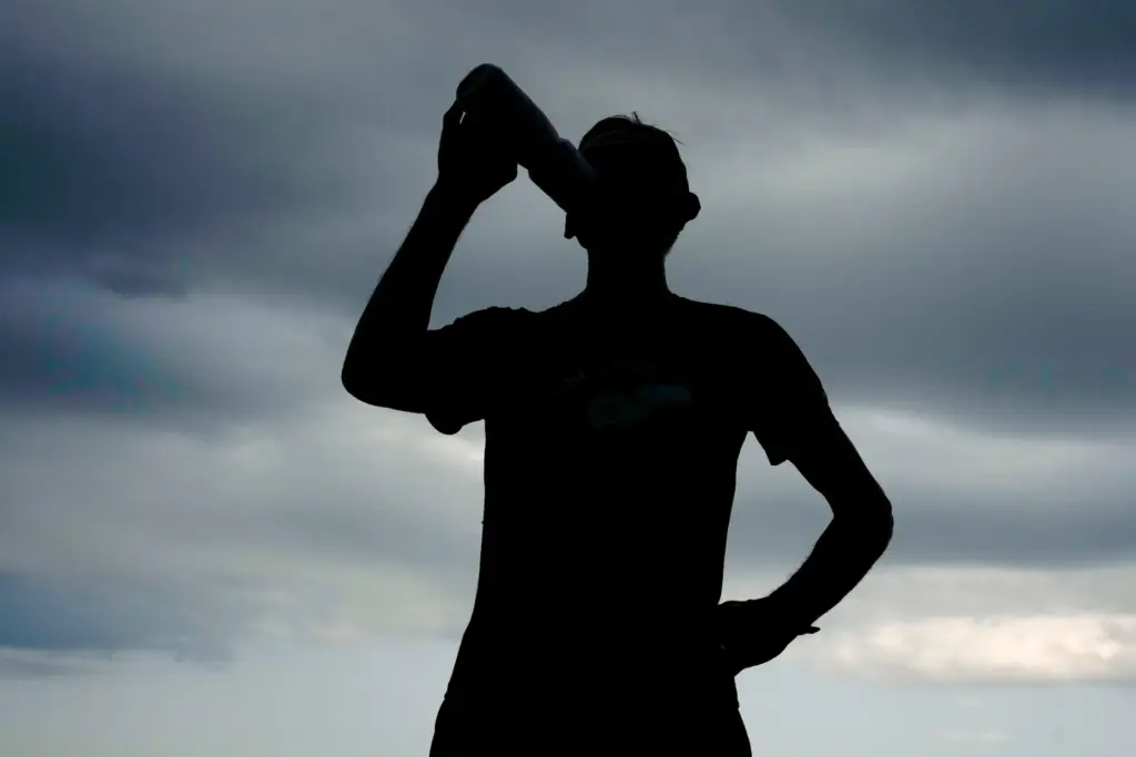 Paul Grinvalds takes a drink after a run with the Raccoon River Running Club.