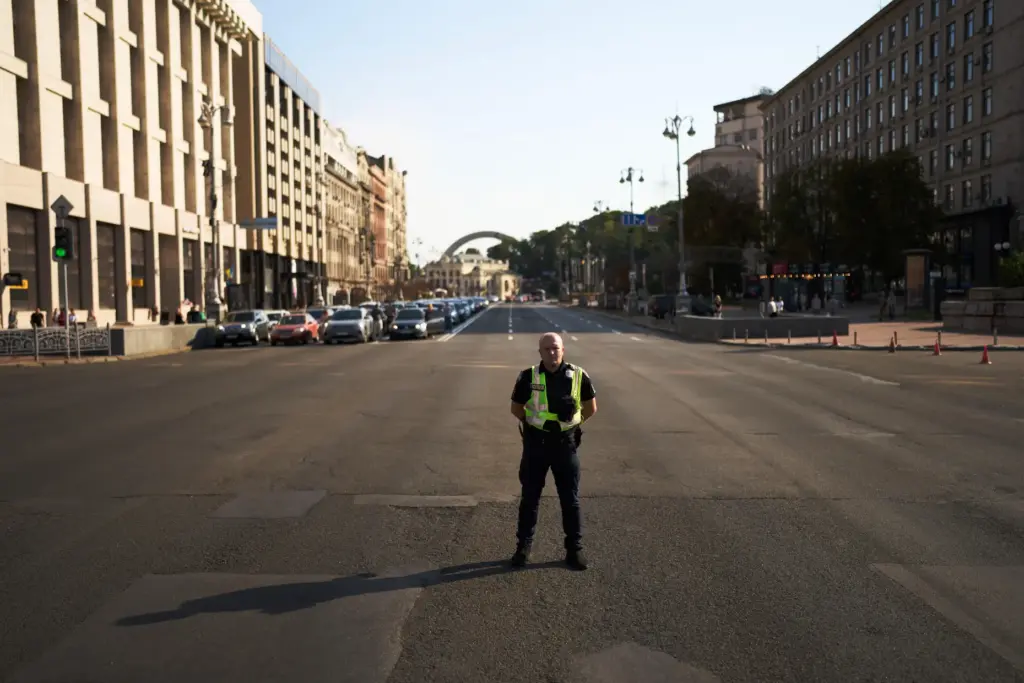 A police officer observes a daily nationwide minute of silence in memory of soldiers killed.