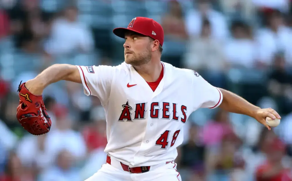 Angels starting pitcher Reid Detmers throws to the plate during...