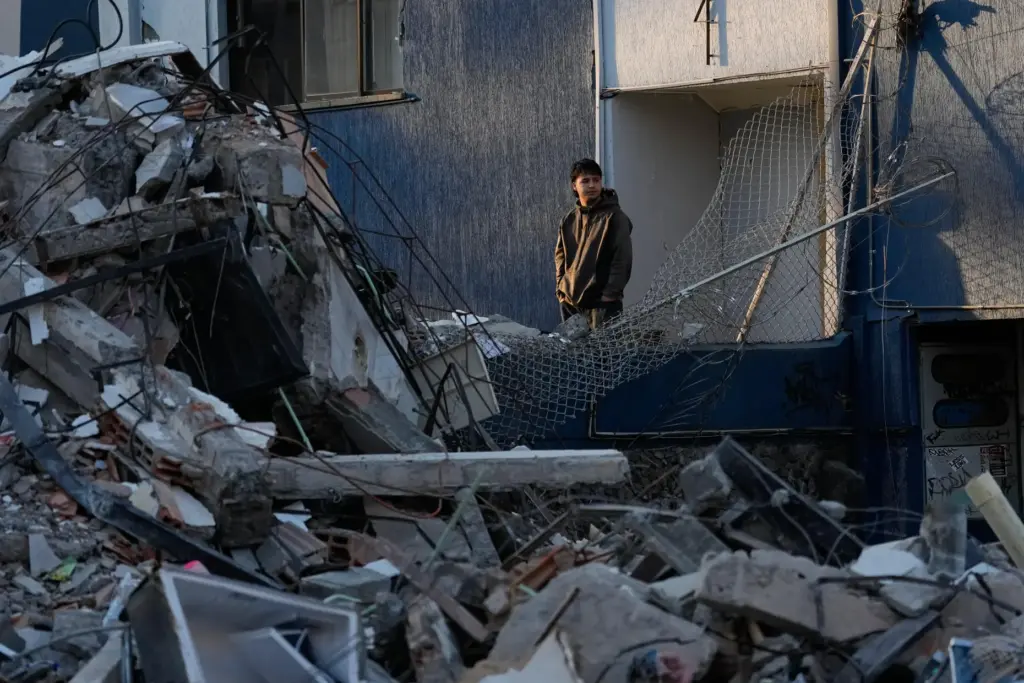 A neighbor looks at a collapsed building the day after an earthquake struck Pereira, Colombia.