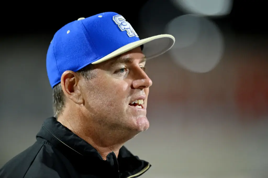 Santa Margarita head coach Carson Palmer talks with his team...