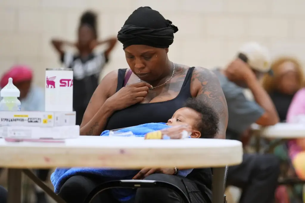 A woman sits inside the City Life Center as she...