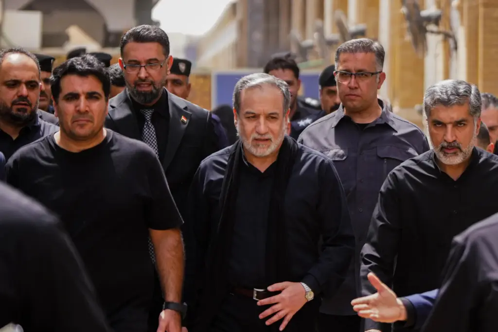 Iranian Foreign Minister Abbas Araghchi is surrounded by security personnel.