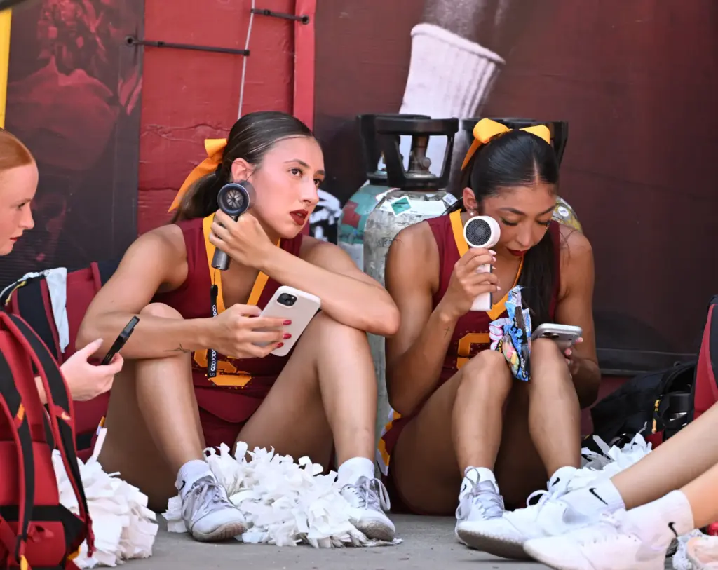USC Trojans USC Song Leaders attempt to stay cool sitting...