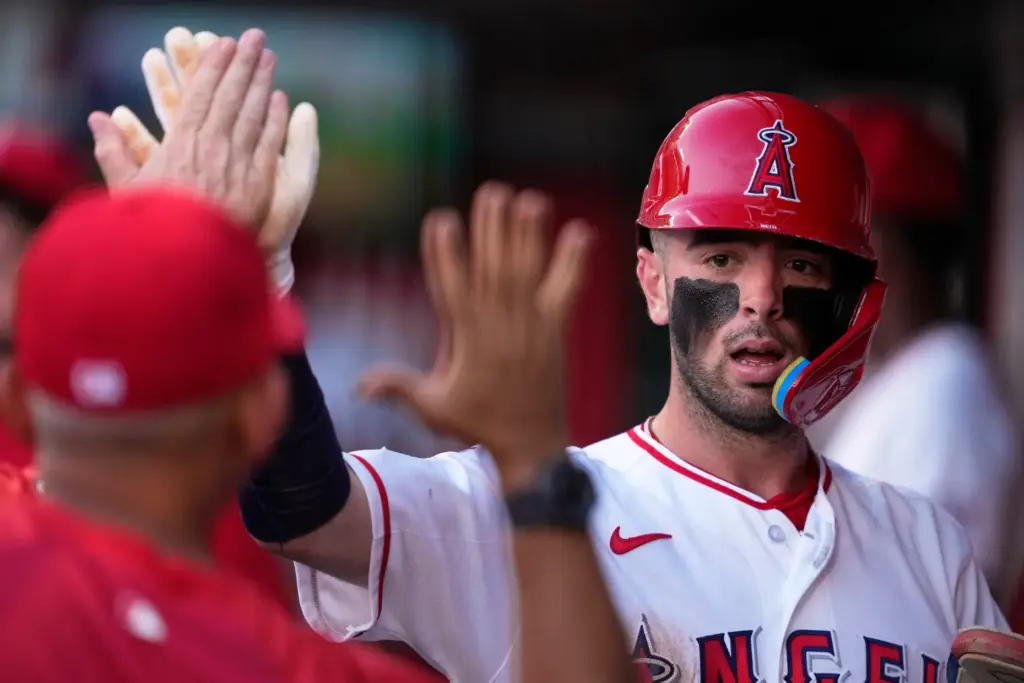 The Angels’ Zach Neto is congratulated by teammates in the...