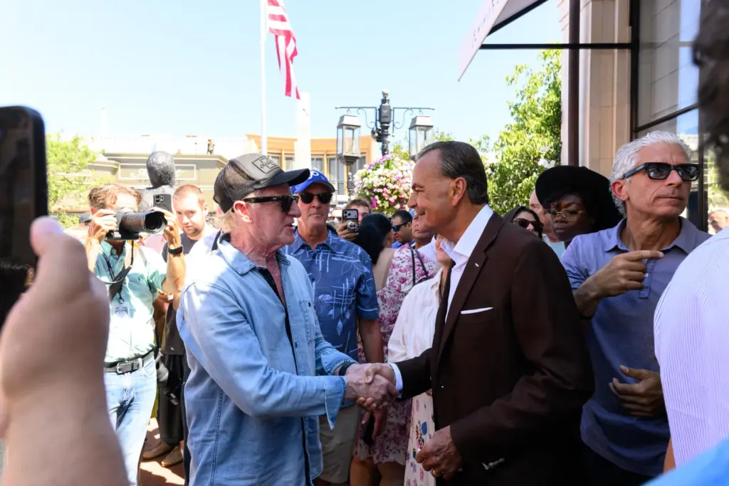Businessman Rick Caruso greets attendees of the grand reopening of...