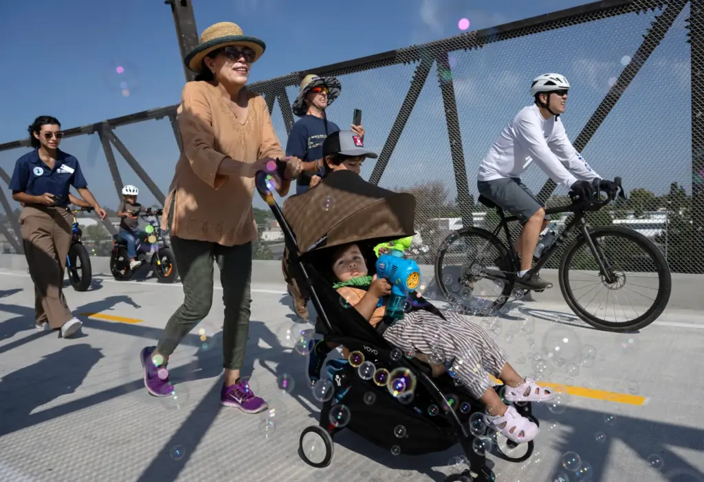 Pedestrians and bicyclists use the newly opened Jeffrey Open Space...