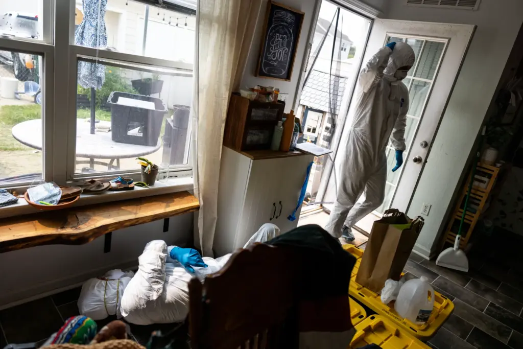 Chief Damage Controlman Matt Campbell enters the contaminated family home...