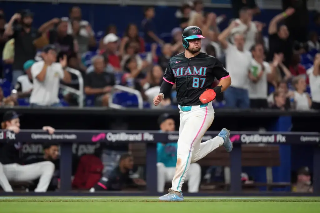 The Miami Marlins’ Jakob Marsee runs home to score on...