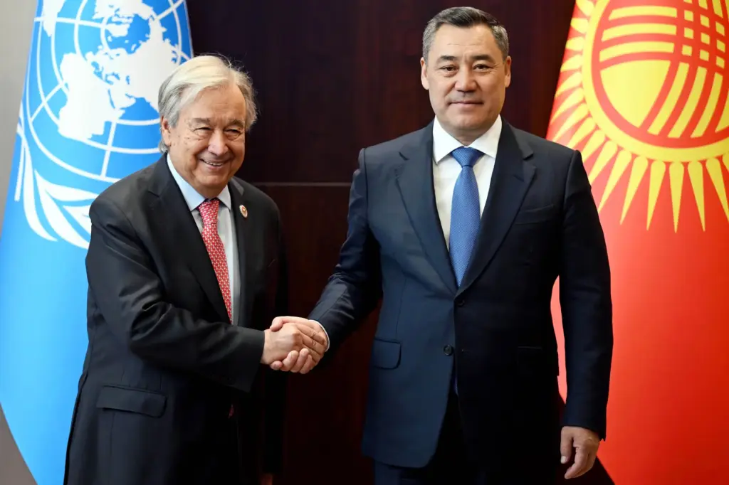 United Nations Secretary-General Antonio Guterres and Kyrgyz President Sadyr Zhaparov shake hands.