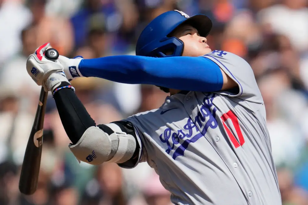 Dodgers’ Shohei Ohtani hits a single against the Detroit Tigers...
