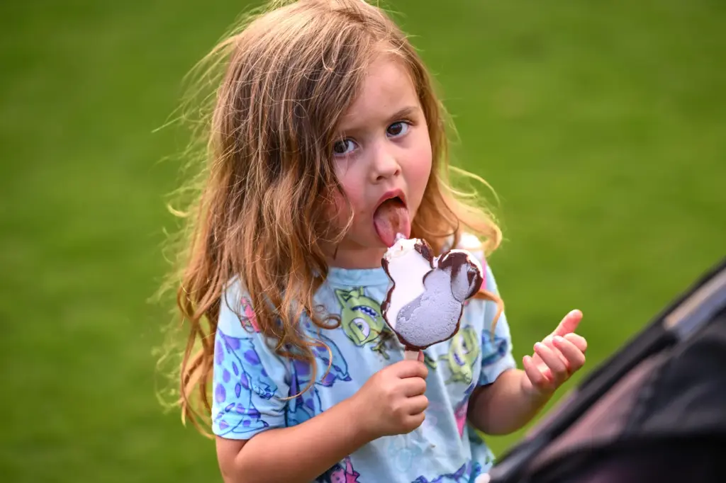 Katrina Palacios, 3, eats her Mickey ice cream during Disneyâs...