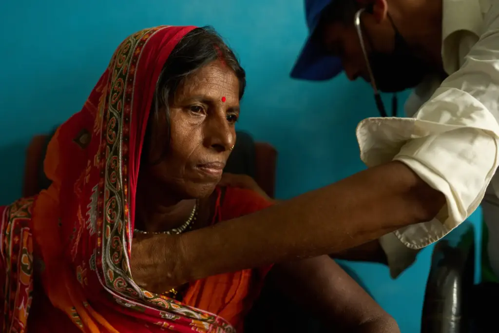 A woman receives an examination from a doctor inside a clinic in Gaur, Nepal.