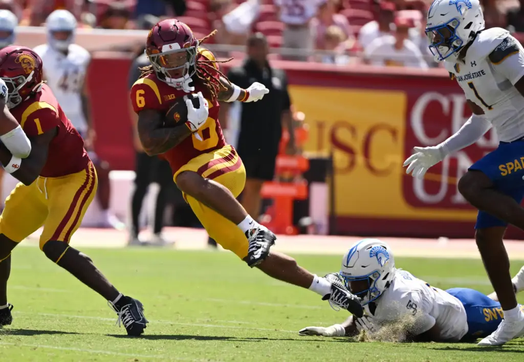 Running back Deshonne Redeaux (6) of the USC Trojans runs...