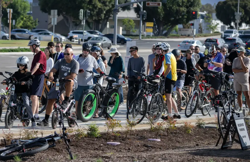Bicyclists cram the sidewalk on Jeffrey Road near Walnut Avenue...