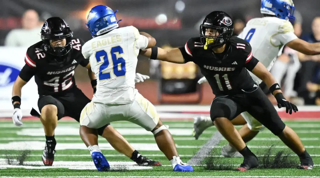 Santa Margarita running back Adrian Petero (26) tries to avoid...