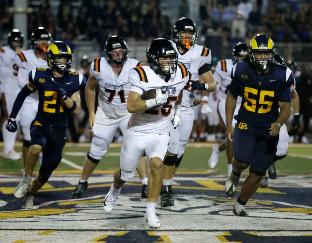 Huntington Beachs Nathan Santillian (25) races down field with the...