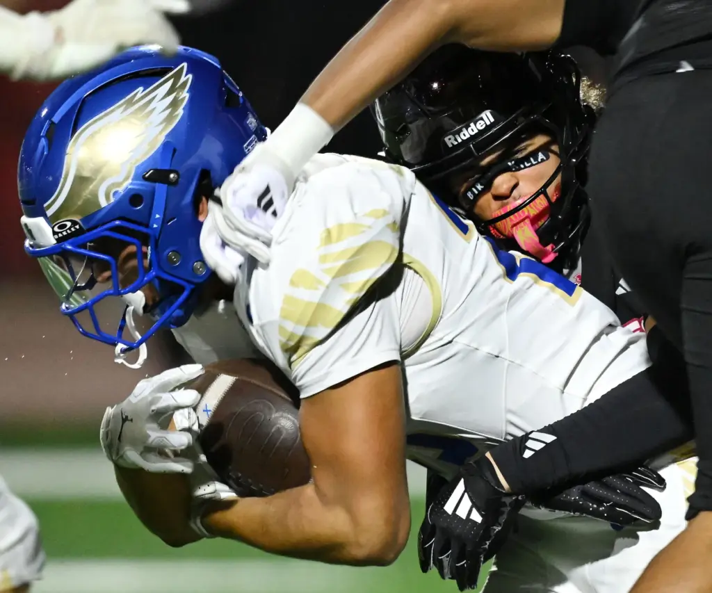 Centennial ath Koti Fultz (20) tackles Santa Margarita kick returner...