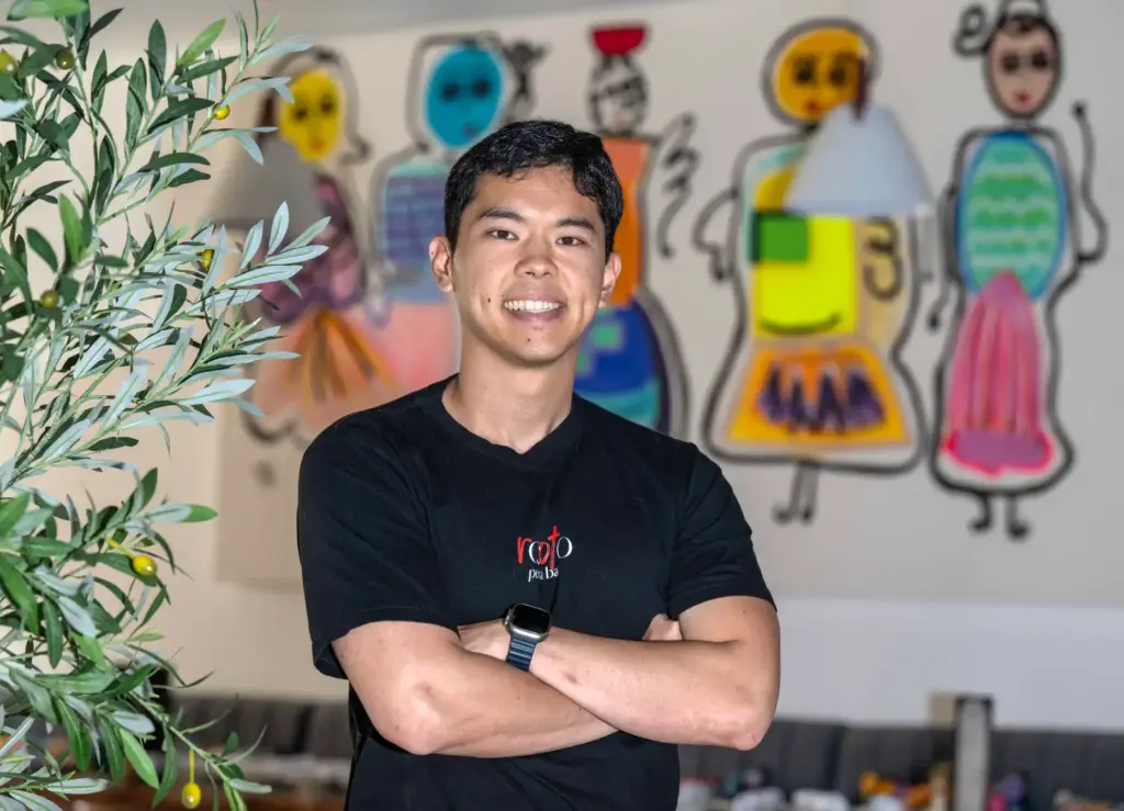 Chef-owner Christian Chan stands in the dining room of his...