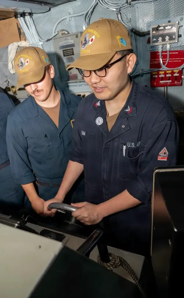 Electronics Technician Nuclear 2nd Class Jonathan Kim, right, pilots Nimitz-class...