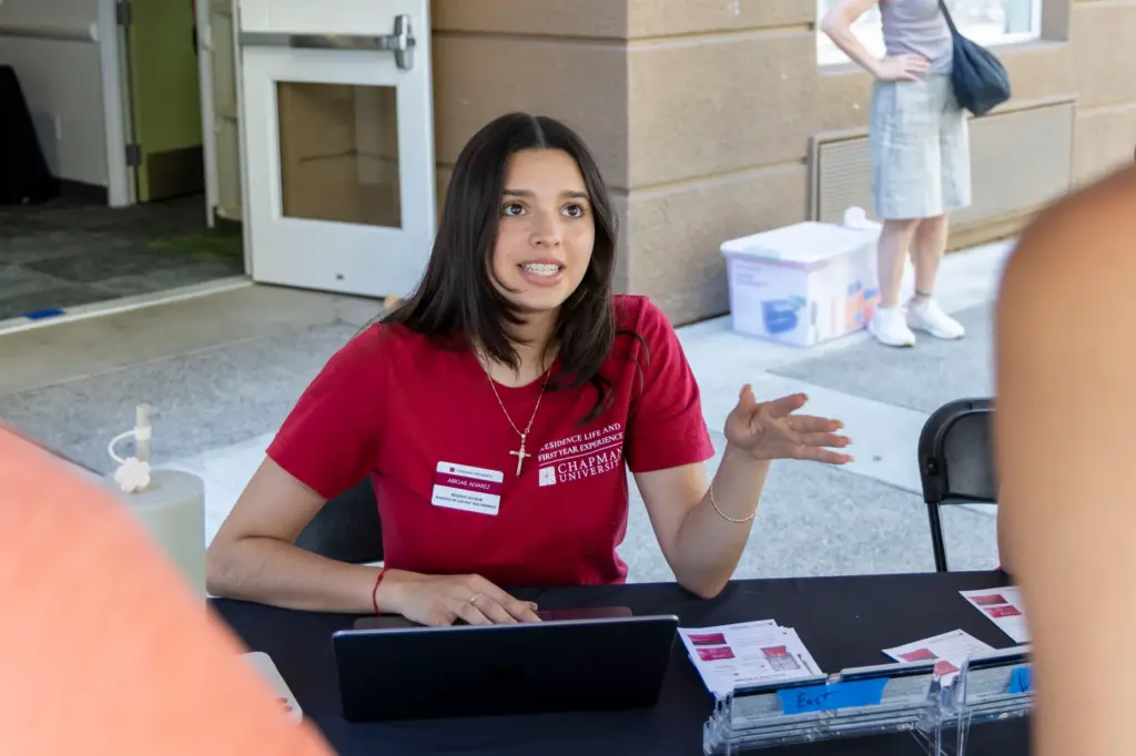 Resident Advisor Abigail Alvarez talks with first-year Nalani Walsh and...