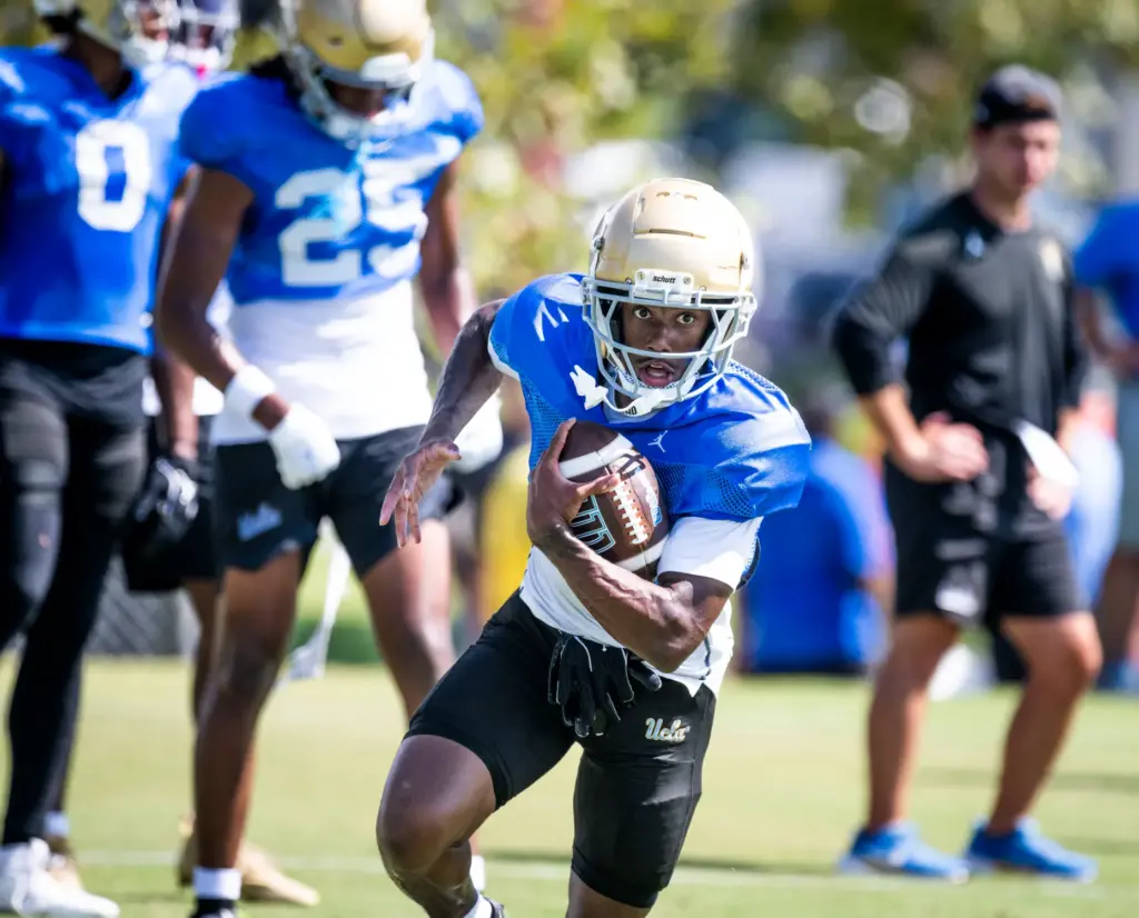 UCLA wide receiver Semaj Morgan runs with the ball as...