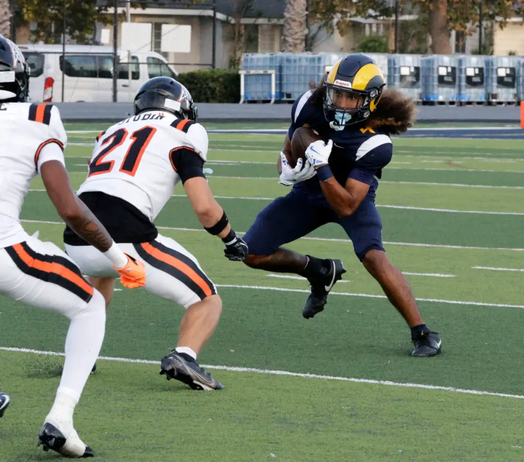 Millikans Aden Taufa (4) looks to get around Huntington Beachs...