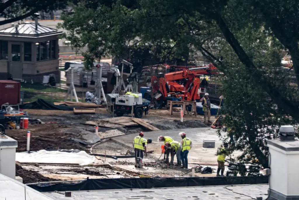 Workers use a jackhammer on the helipad on the South...