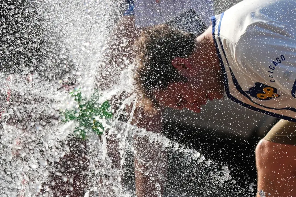FILE – A person cools off in front of a...