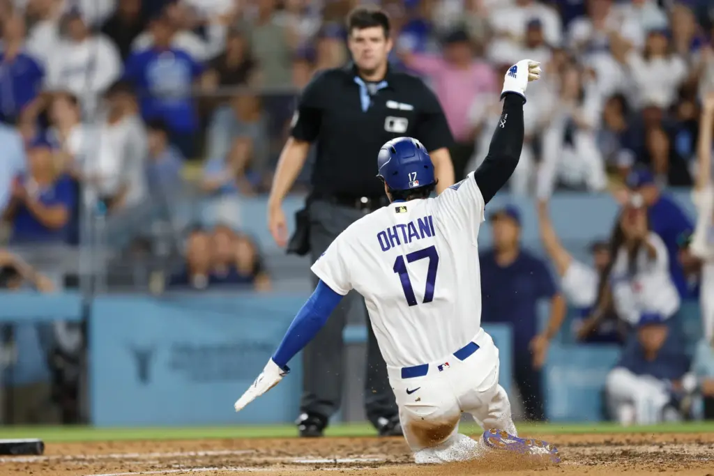 Dodgers star Shohei Ohtani slides home to score the go-ahead...