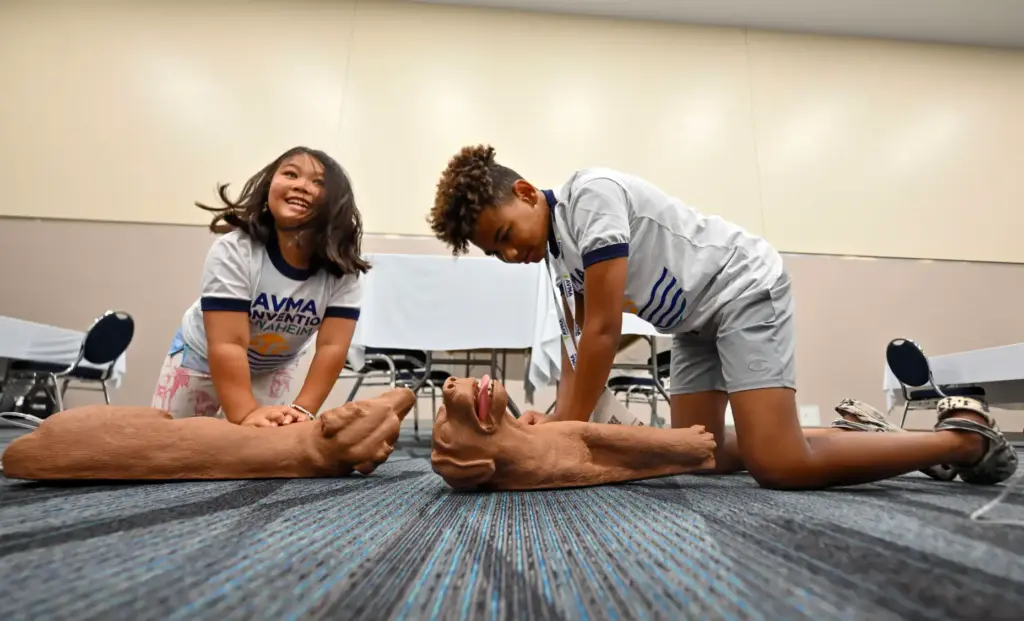 Ariella Topliff Lee, left, and Trenton Connor practice performing CPR...